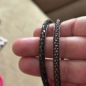 Two bronze bangle bracelets, different styles